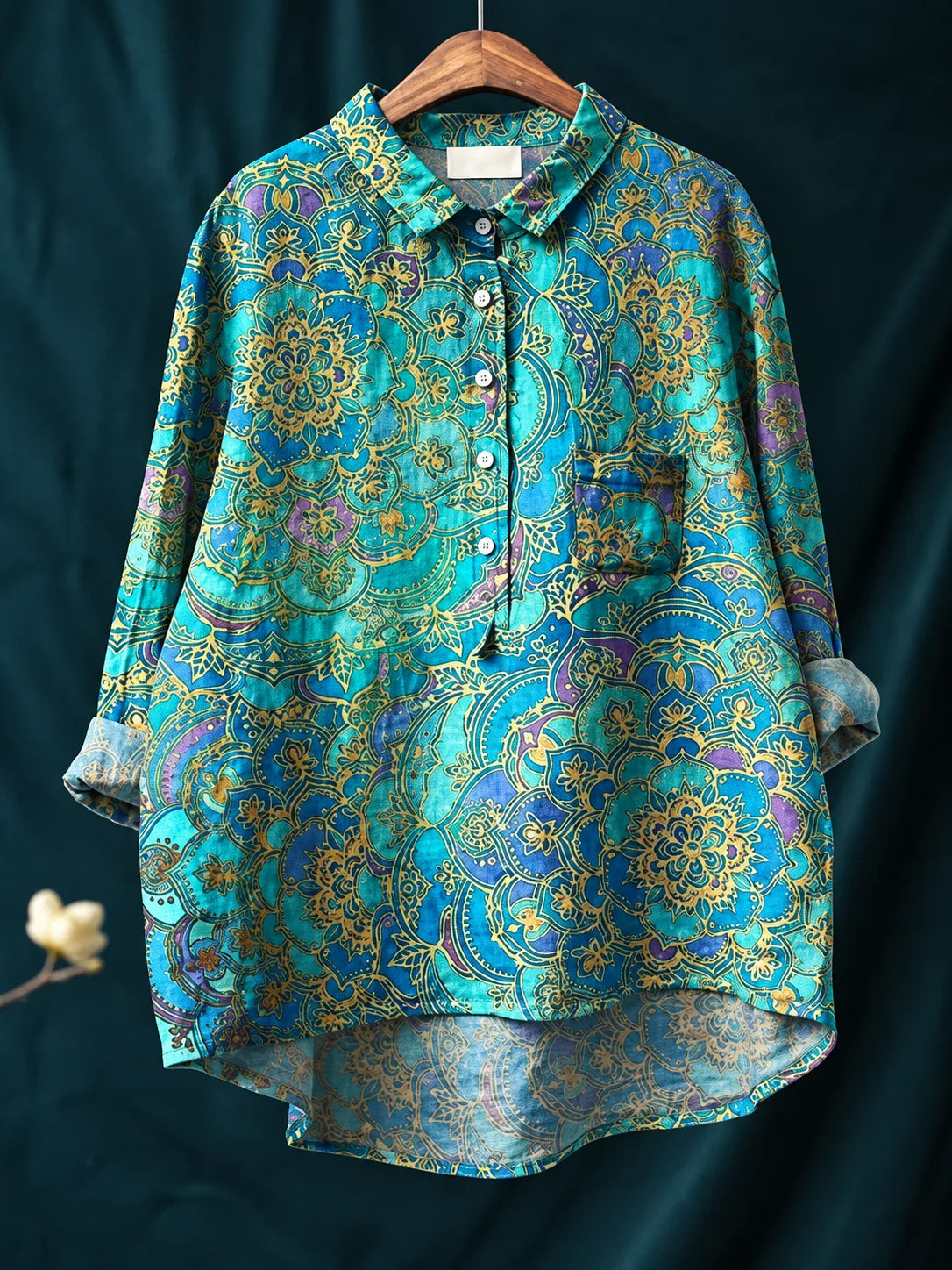 Teal shirt printed with an ornate mandala-style paisley pattern in gold and purple tones