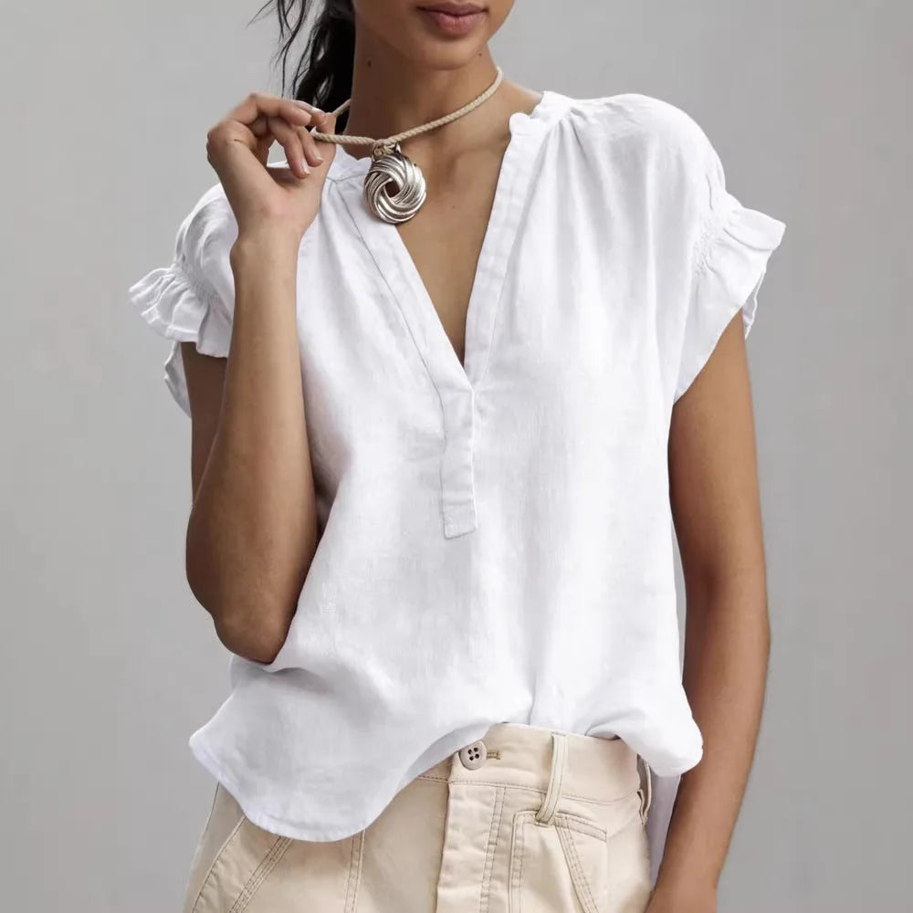 White linen-look blouse with deep V-neckline, button front and ruffled sleeve, shown in close detail