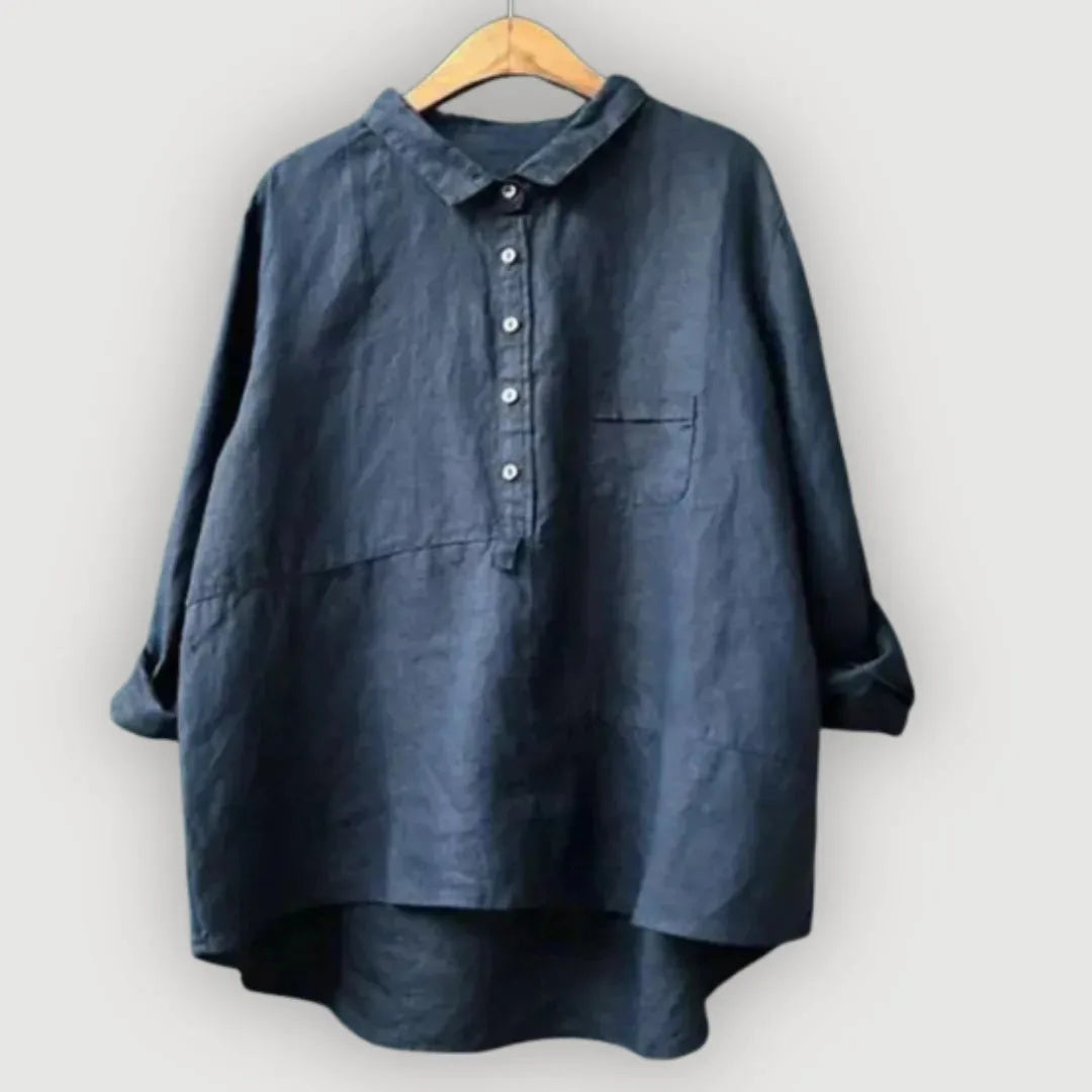Close view of the navy blouse collar and button stand sitting open at the neckline