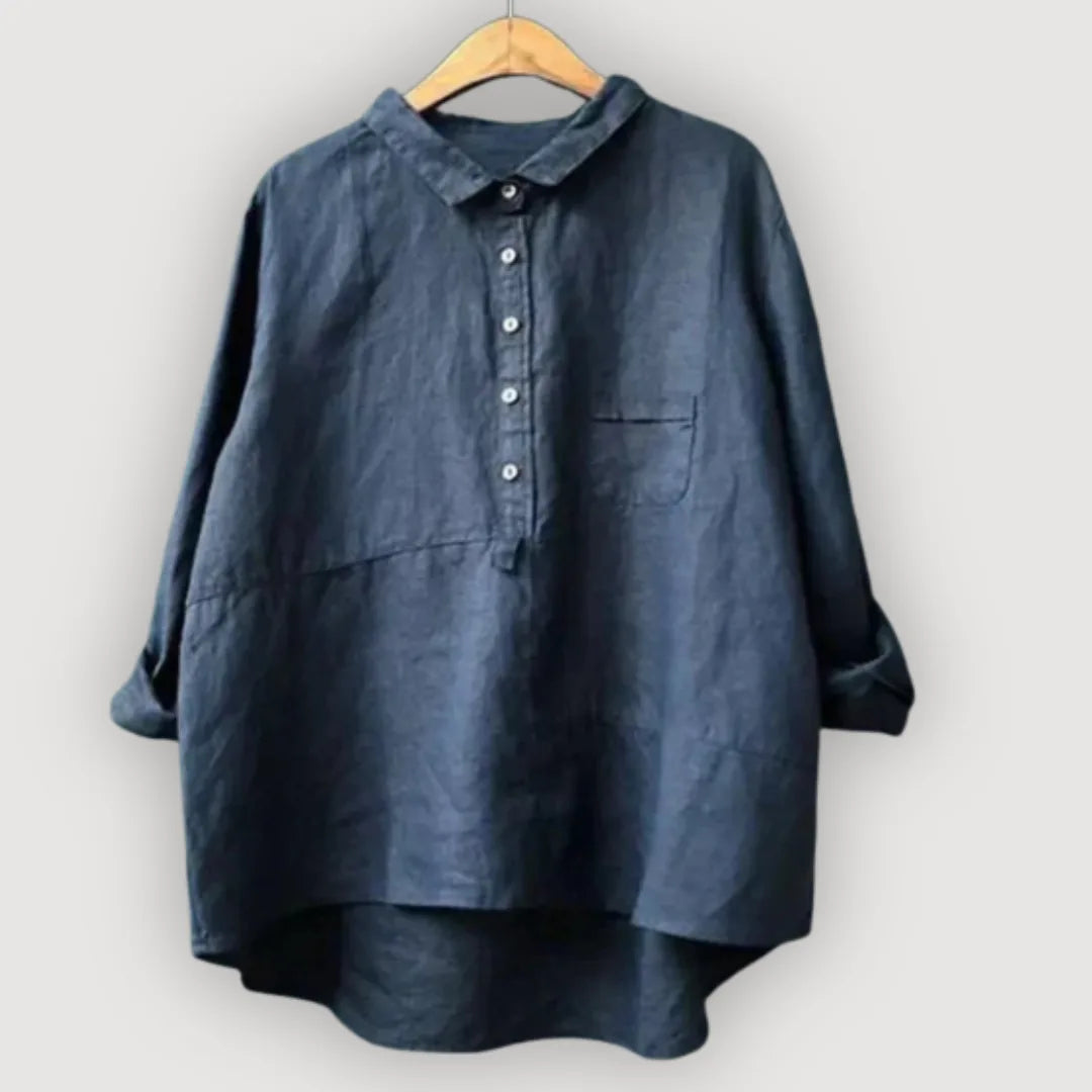 Navy linen blouse with collar, button placket and front pocket, shown on a timber hanger