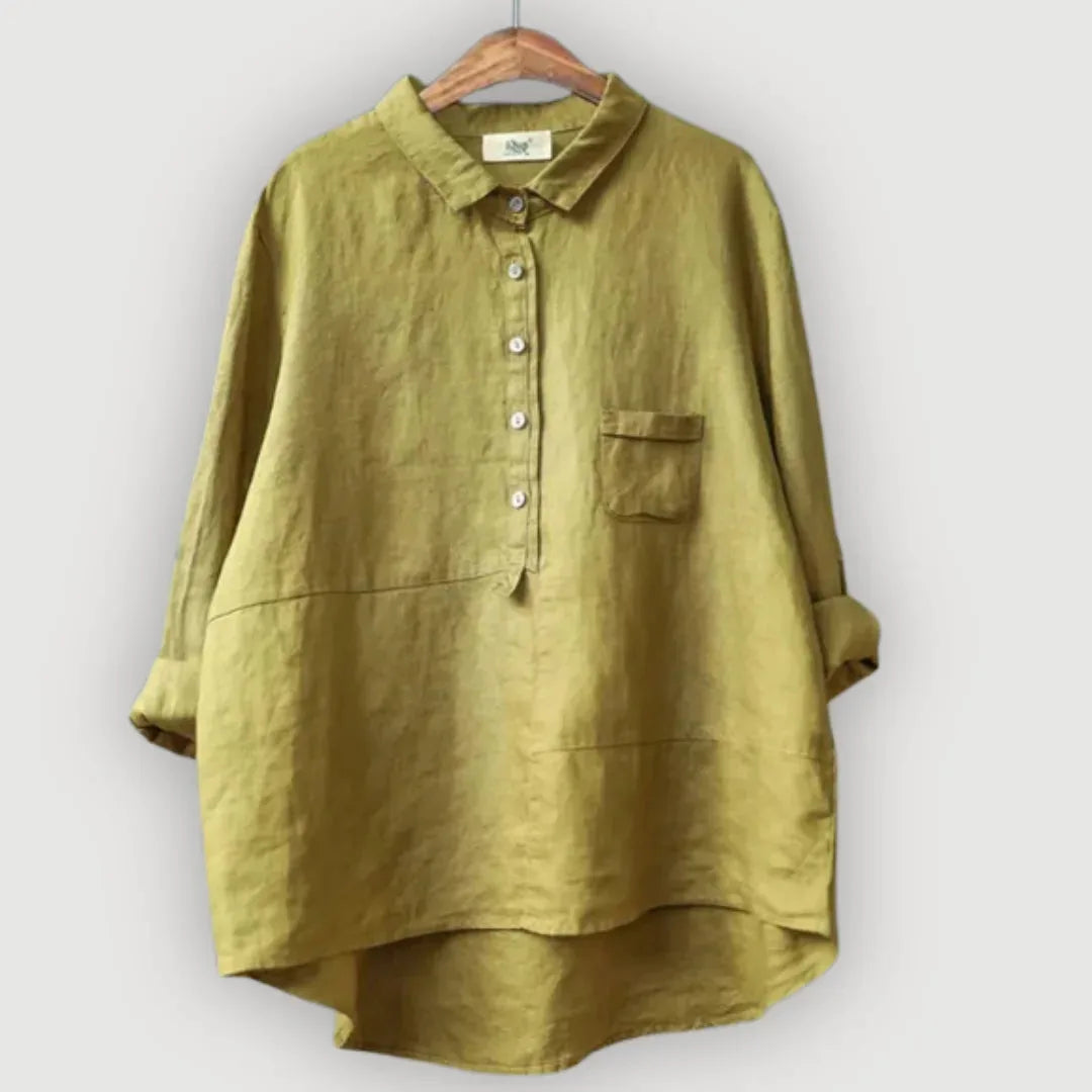 Front view of the olive linen blouse showing its dropped shoulders and high-low curved hem
