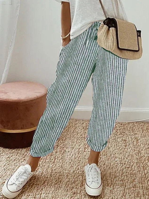 Close-up of waist drawstring tie detail on beige linen relaxed pants with pocket