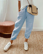 Pale blue linen relaxed pants with elastic drawstring waist and cuffed ankle hems