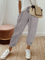 Navy and white striped relaxed pants with cuffed hems, close side view of fabric texture