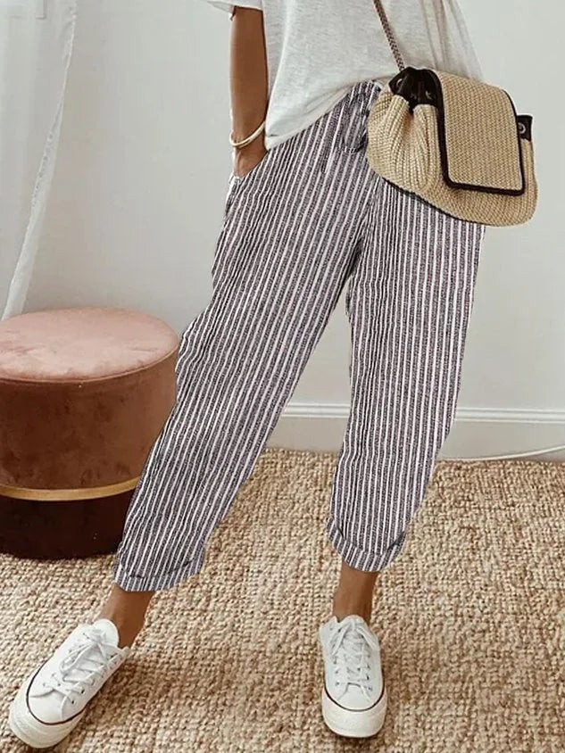 Navy and white striped relaxed pants with cuffed hems, close side view of fabric texture