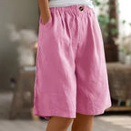 Bright pink relaxed-fit shorts with elastic waistband, button trim and roomy side pocket