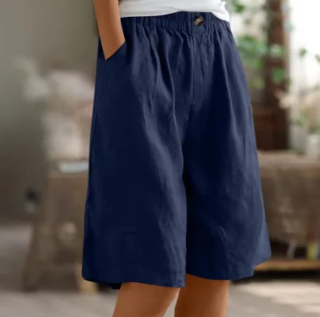 Navy blue knee-length shorts with elasticated waist and visible stitched front pleats