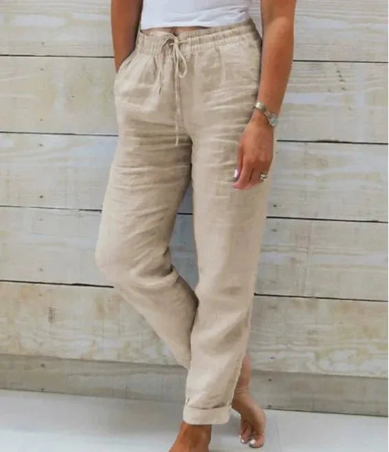 Beige linen trousers shown from the front with elasticated drawstring waistband and relaxed straight leg