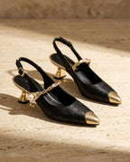 Black jacquard slingback kitten heels with gold pointed toe cap, twisted gold and pearl vamp strap and sculpted gold heel.