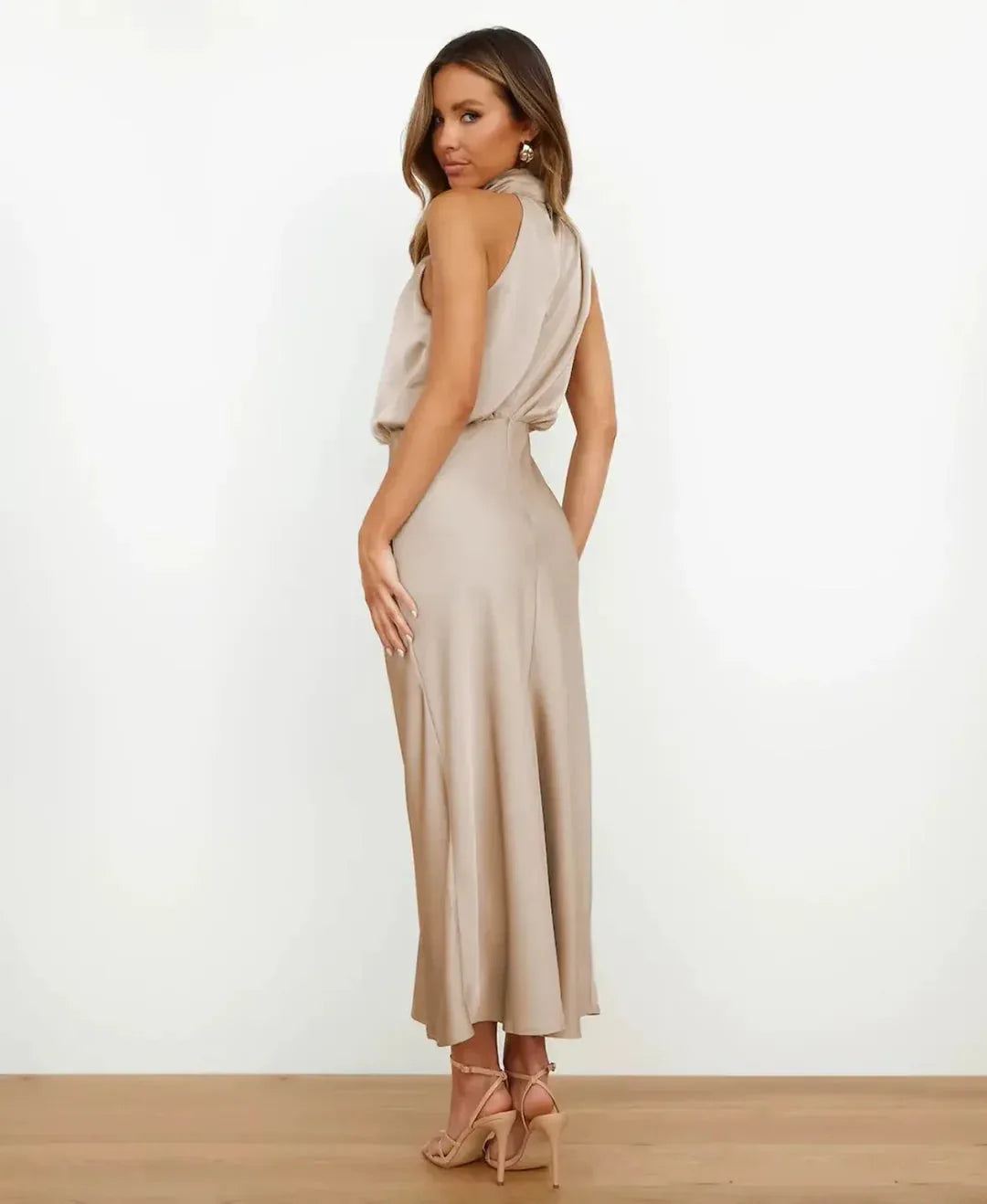 Back view of champagne satin dress showing open back and blouson bodice detail