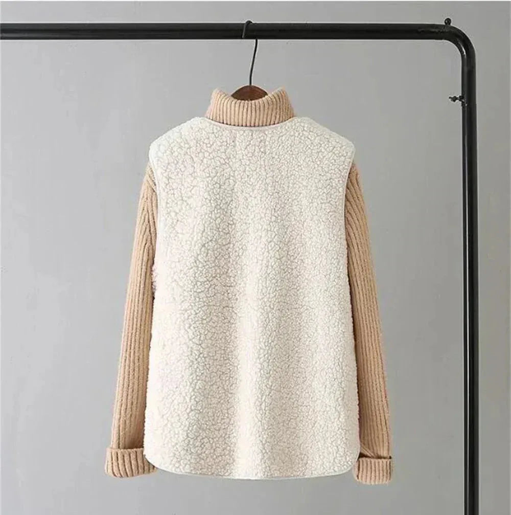 Back view of a white sherpa fleece vest on a hanger, worn over a camel ribbed turtleneck jumper