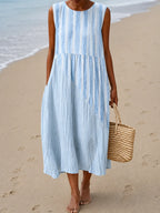Sleeveless midi dress in soft blue and white tie-dye style stripes with a diagonal colour block panel