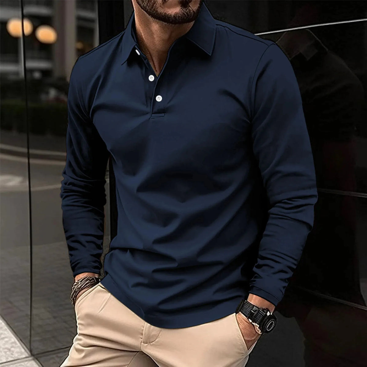 Navy long-sleeve polo shirt with contrast white buttons, shown buttoned up to the collar on a model