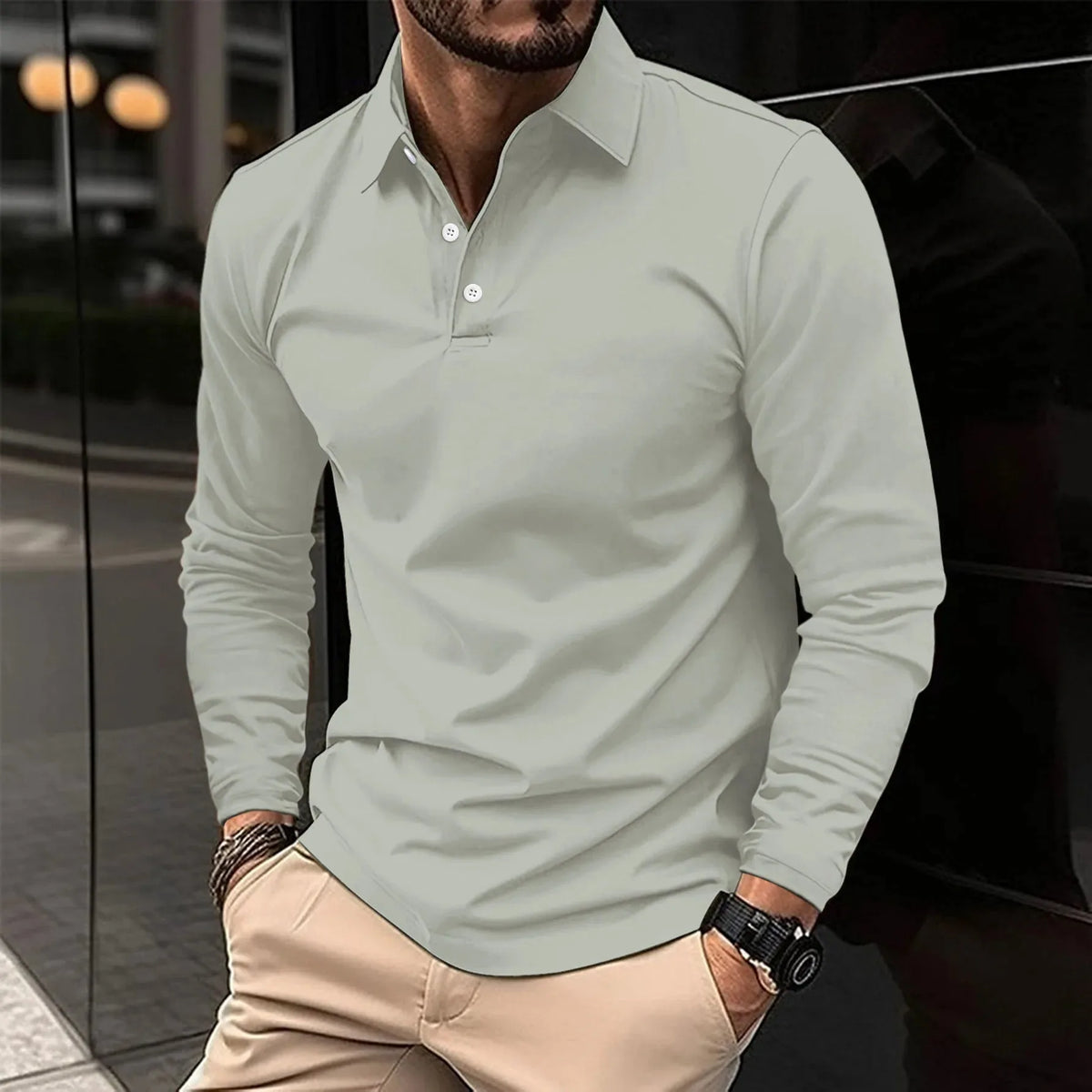 Sage green long-sleeve polo shirt with a structured collar, close-up view of the fabric texture