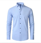 Front product shot of a light blue slim-fit men's shirt with spread collar and dark button detailing