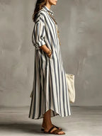 Side profile of the blue striped shirt dress highlighting the relaxed fit and collared neckline