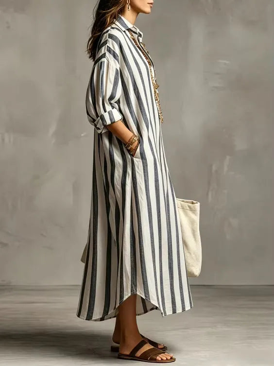 Side profile of the blue striped shirt dress highlighting the relaxed fit and collared neckline