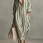 Close-up of a green striped maxi shirt dress with V-neck collar and layered necklaces