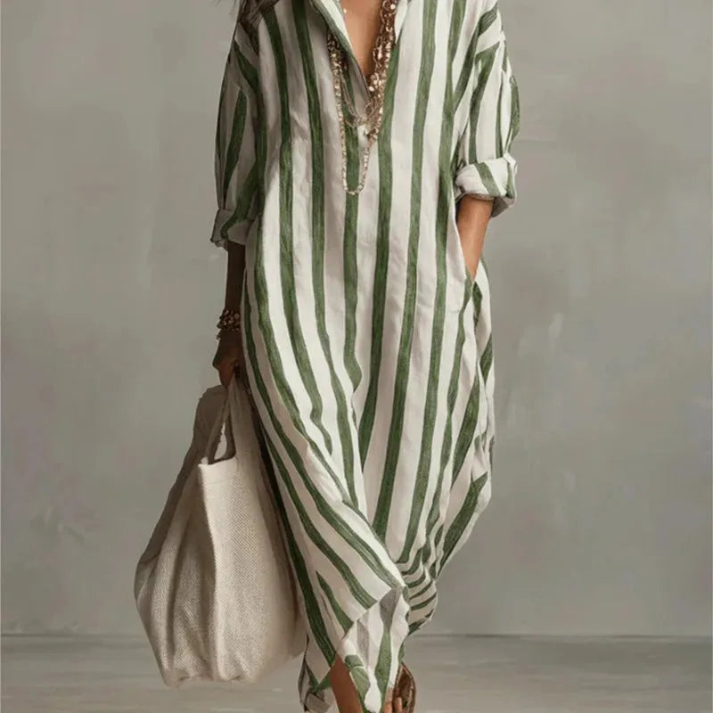Close-up of a green striped maxi shirt dress with V-neck collar and layered necklaces