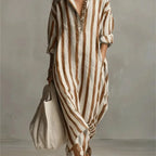Front view of a green and white striped maxi dress with long sleeves and front pocket