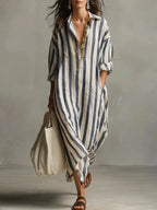 Front view of a red striped maxi shirt dress with pockets and a woven tote bag