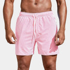 Front view of pink and white striped boardshorts with elastic waistband and drawstring.