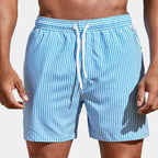 Front view of light blue and white striped boardshorts with white drawstring tied at front.