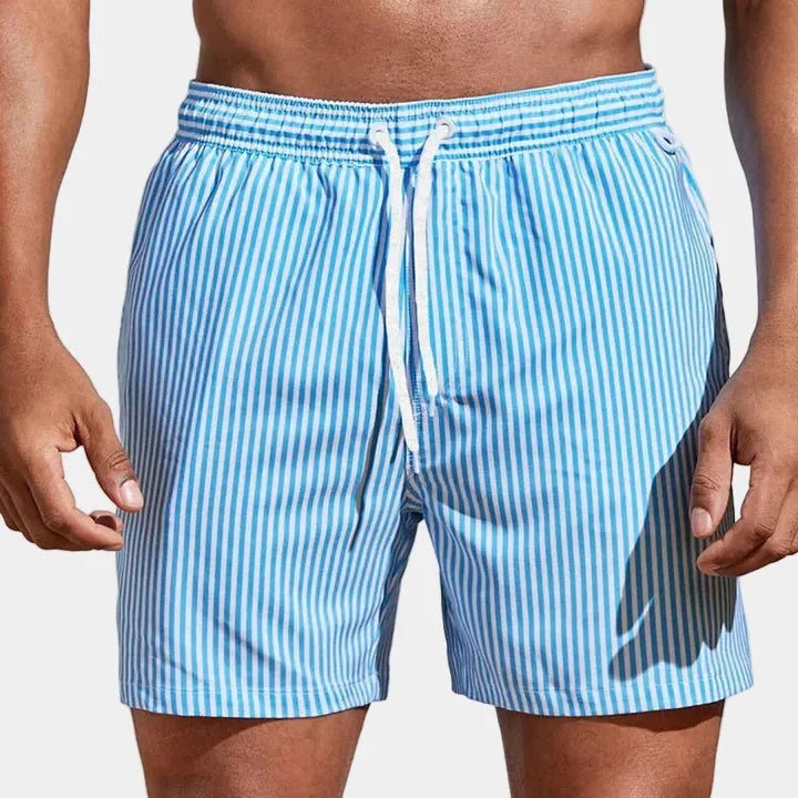 Front view of light blue and white striped boardshorts with white drawstring tied at front.
