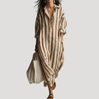 Front view of the maxi shirt dress in earthy tan and white stripes, falling loosely to ankle length
