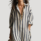 Close-up of the open collar and rolled three-quarter sleeve on the blue striped linen shirt dress