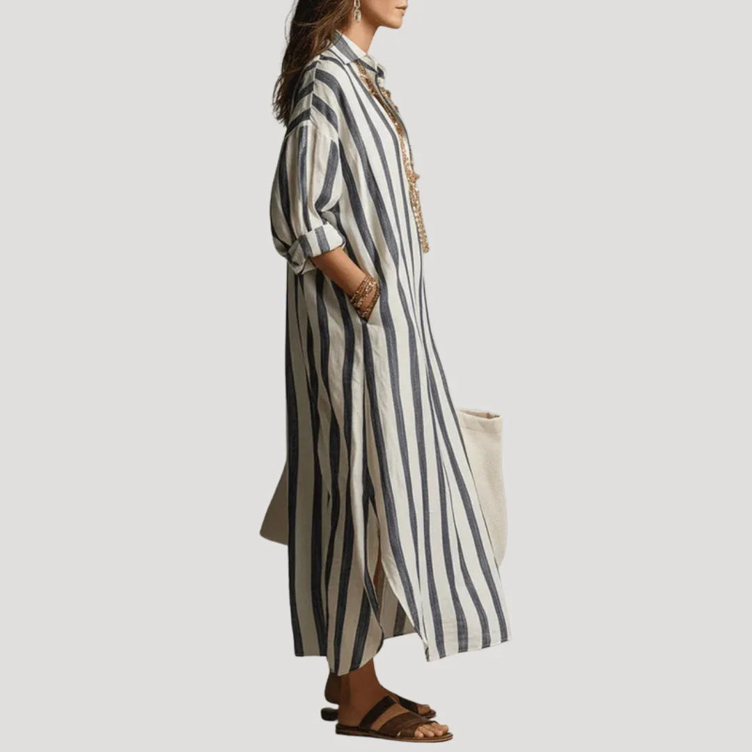 Side profile view showing the relaxed silhouette and side slit of the blue striped linen shirt dress