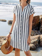 Close-up of the grey and white striped fabric with button detailing against a rocky beach backdrop