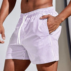 Side view of lilac and white striped boardshorts with white drawstring waist and hand in pocket
