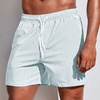 Front view of sage green and white striped boardshorts with elastic drawstring waistband