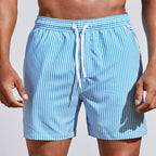 Front view of sky blue and white striped boardshorts showing drawstring waist and relaxed fit