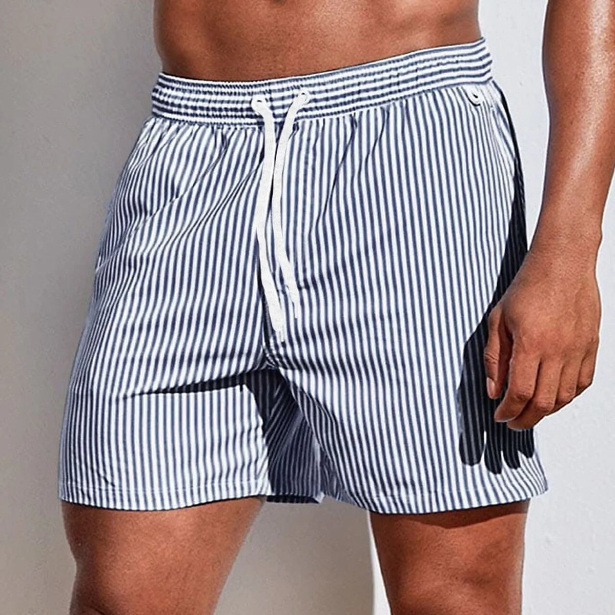 Side view of navy and white striped boardshorts with white drawstring and visible side seam