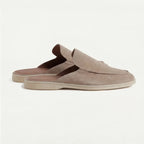 Top-down view of a navy suede backless loafer showing the rounded toe shape and open heel cut