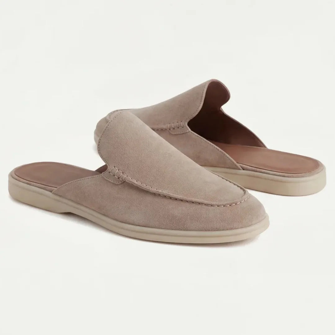 Close-up angle of a beige suede mule highlighting the soft nubuck-like texture and stitched seam detail