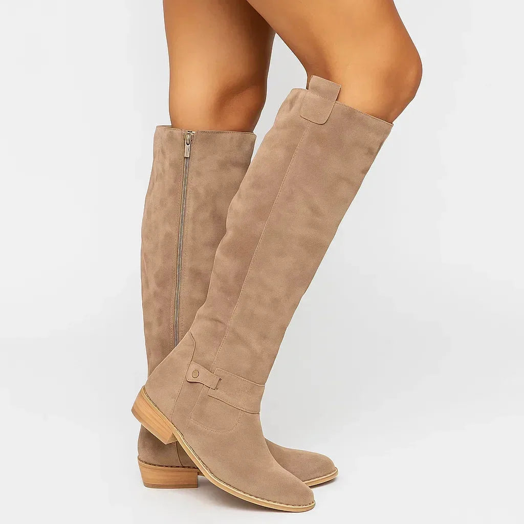 Side view of taupe suede knee-high boot with gold zip and stacked wood-look block heel
