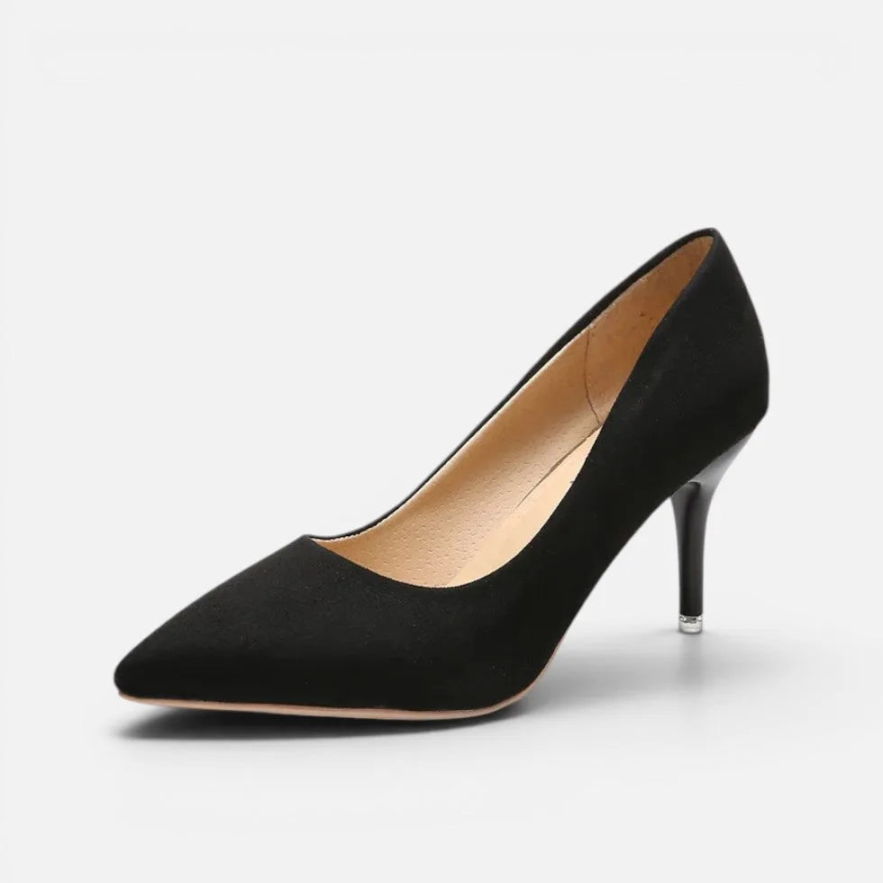 Side view of black suede pointed toe pump with slim kitten heel and cushioned footbed