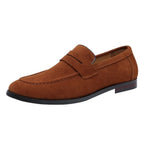 Side view of a tan suede penny loafer with round toe and stitched apron detail