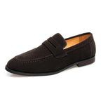 Dark brown suede penny loafer showing the rounded toe and low stacked heel