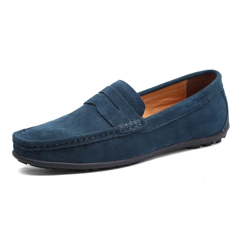 Navy suede penny loafer shown from the side with classic saddle strap stitching detail