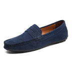 Dark navy suede penny loafer viewed from above showing stitched moc toe and heel shape