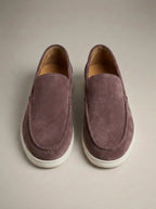 Overhead shot of mauve suede slip-on loafers with white sole and visible apron stitching detail