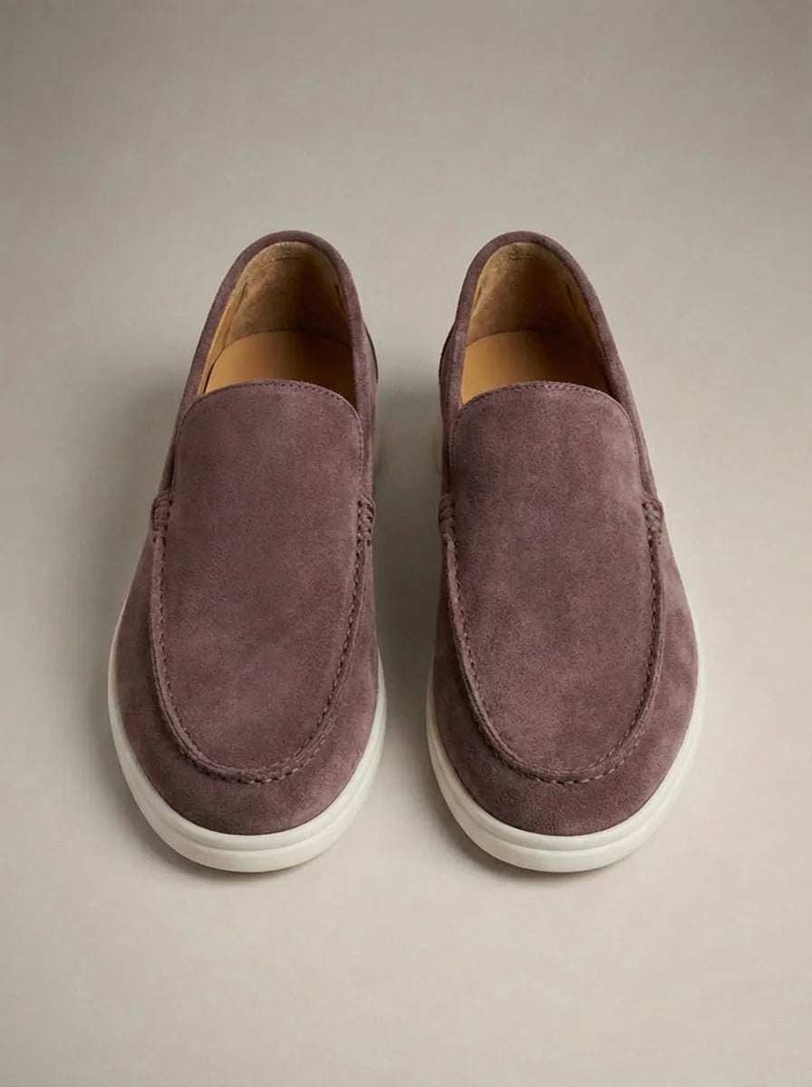 Overhead shot of mauve suede slip-on loafers with white sole and visible apron stitching detail