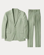 Flat lay of the sage green linen blazer and trousers shown together against a plain background
