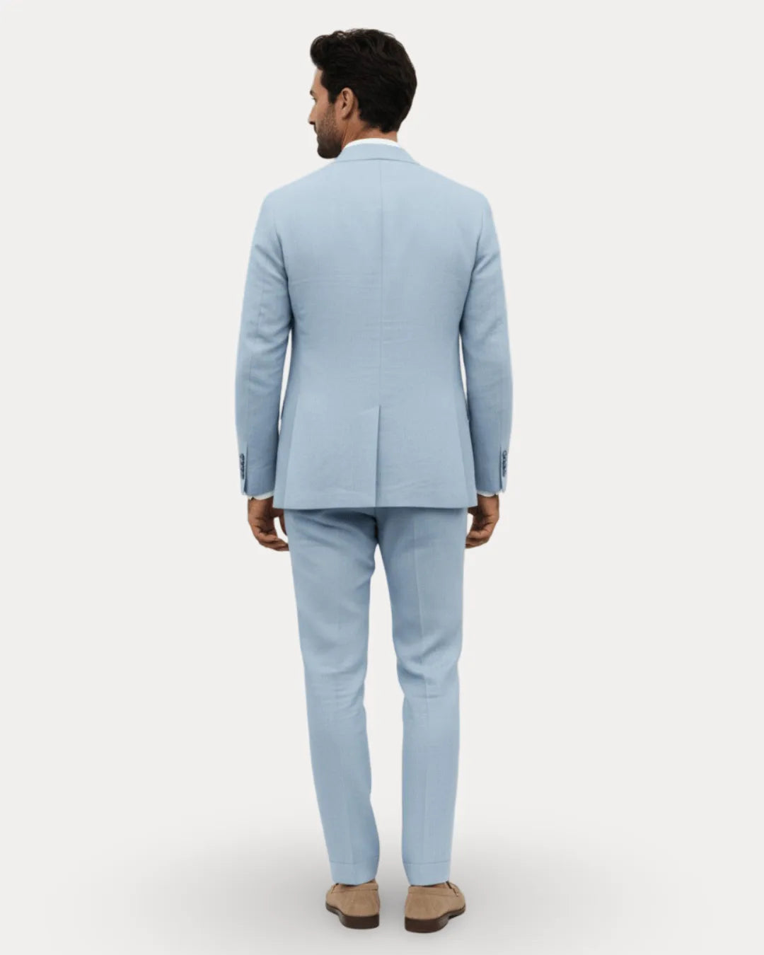 Back view of the pale blue linen suit showing the single-vent blazer and straight-leg trousers