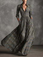 Front view of a grey tartan maxi dress with notched collar, V-neckline, button front bodice and flared skirt with pockets