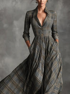 Close-up of the grey tartan dress bodice showing the collar, V-neckline and two decorative buttons at the waist